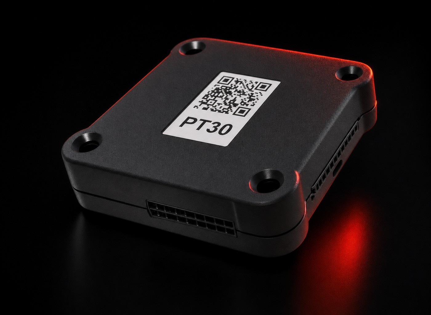 PT30 logging device photographed on an obsidian surface with a signal-red rim light along its edges